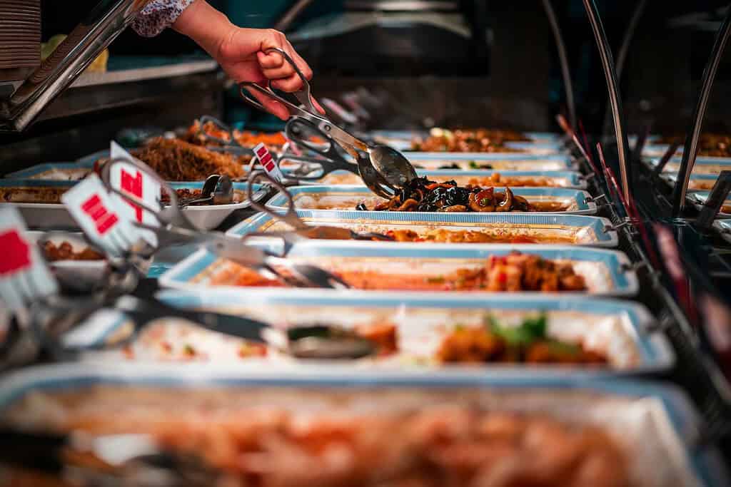 plenty of food items at a buffet 