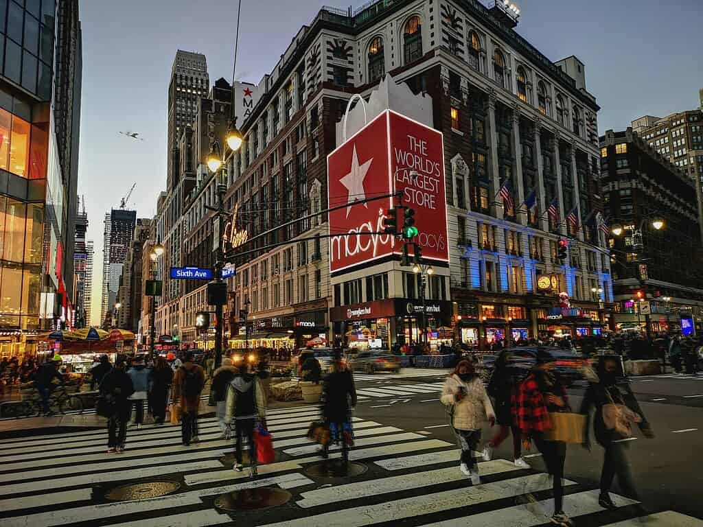 tourist and locals crossing the street during the holiday time with the Macy's store in the background 