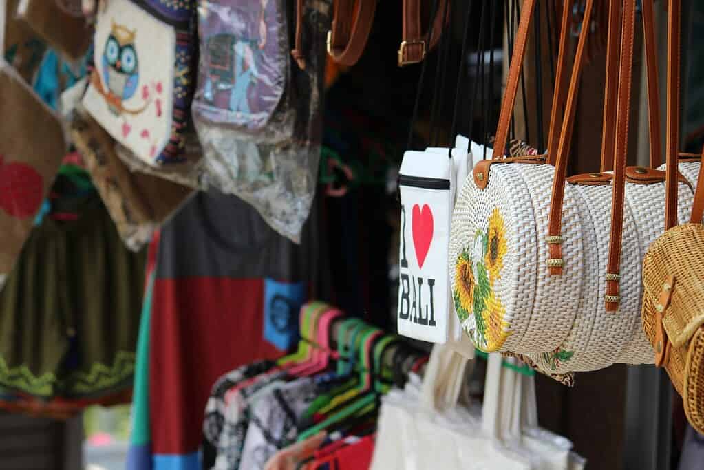 several souvenir bags displayed at a shop in Bali