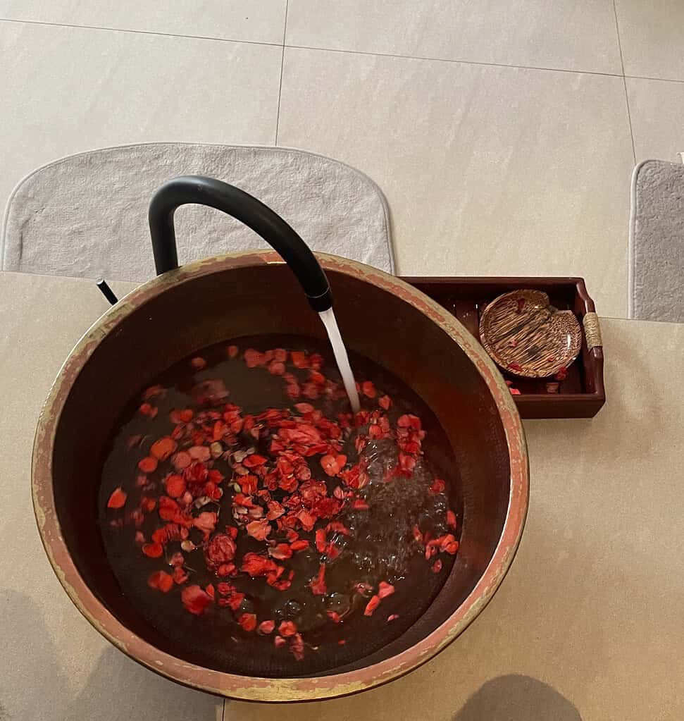flower petals in water under a sink for a Balinese Massage