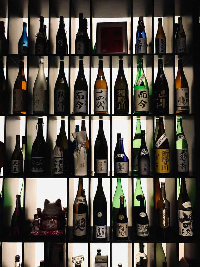 a various amount of Sake displayed at a bar 