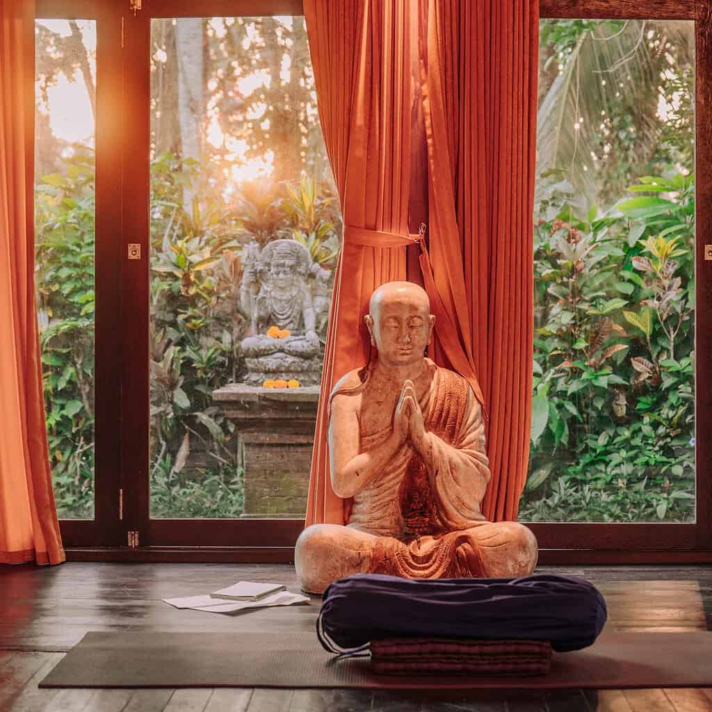 Buddhist statue in a quiet Yoga room in Bali in the morning